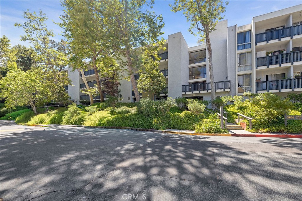3604 West Estates Lane, Unit 114 Rolling Hills Estates, CA 90274 - Photo 44 of 59 a view of a street with potted plants and large trees