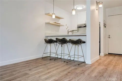 an empty room with wooden floor and ceiling fan