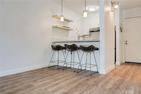 an empty room with wooden floor and ceiling fan