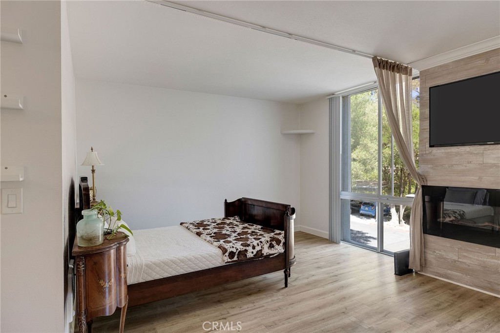 3604 West Estates Lane, Unit 114 Rolling Hills Estates, CA 90274 - Photo 7 of 59 a bedroom with a bed window and a flat screen tv