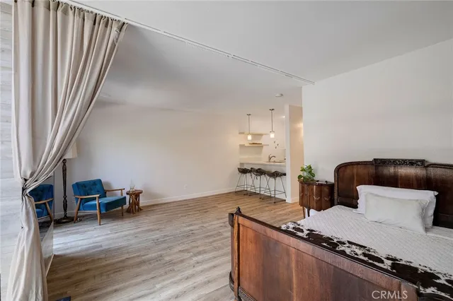 a bedroom with a bed and a television