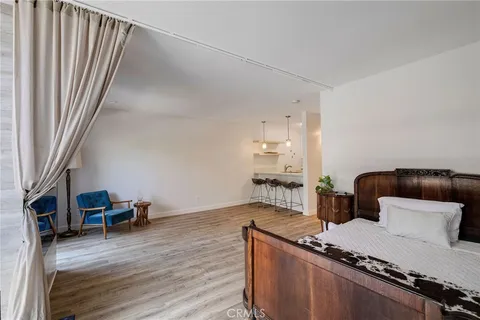 a bedroom with a bed and a television