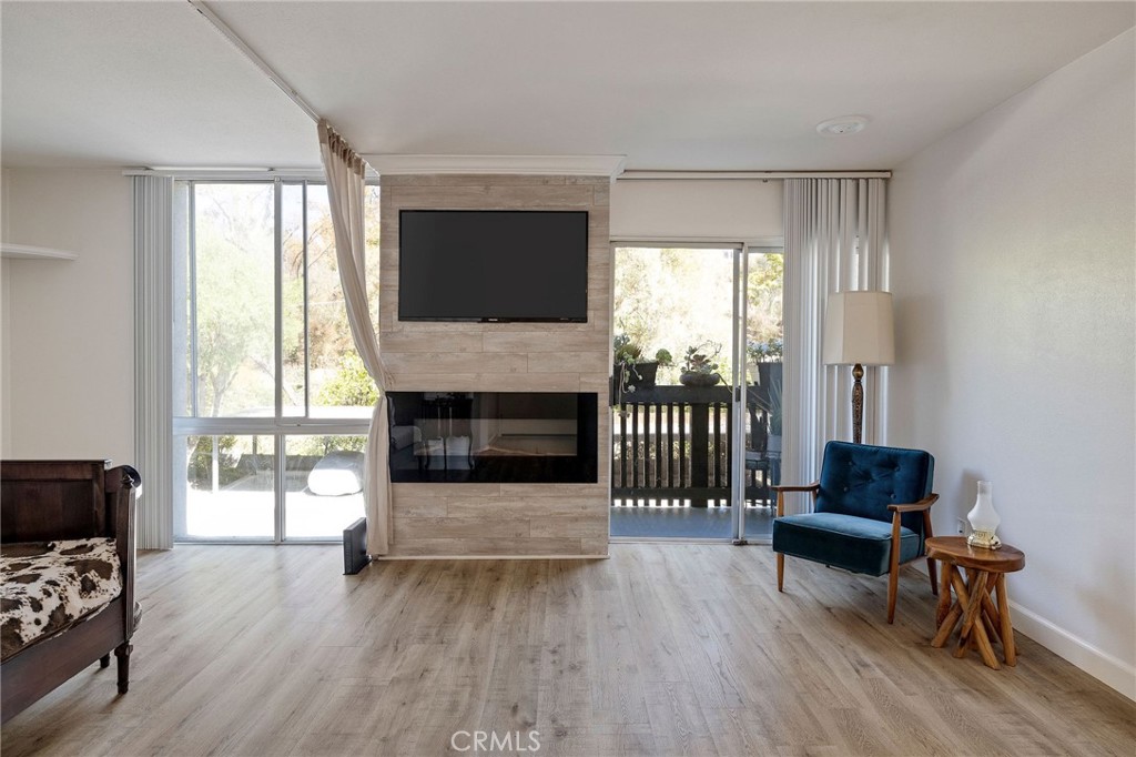 3604 West Estates Lane, Unit 114 Rolling Hills Estates, CA 90274 - Photo 10 of 59 a living room with furniture and a fireplace
