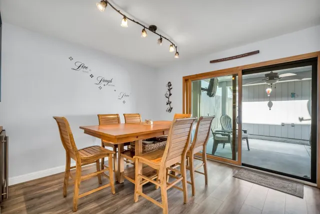 a view of a dining room with furniture large window and wooden floor