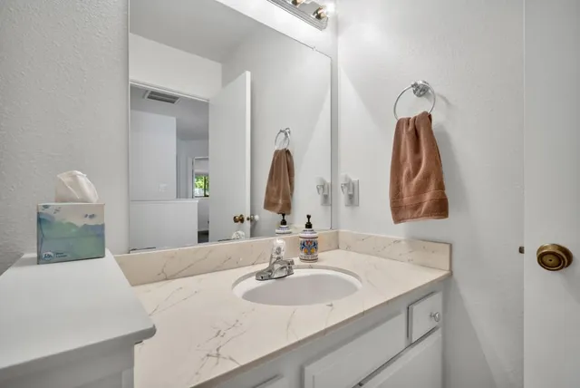 a view of a porch with a table and chairs