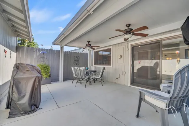 a view of a livingroom with furniture and a ceiling fan