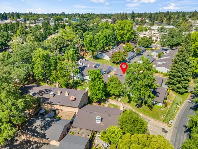 an aerial view of residential house with an outdoor space and seating