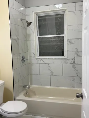 a bathroom with a toilet and shower