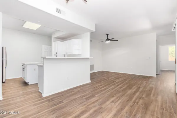 a view of kitchen with wooden floor and electronic appliances
