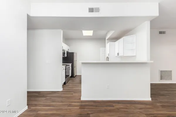 a kitchen with stainless steel appliances a white stove top oven sink and cabinets