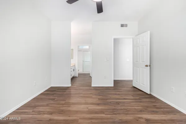 a spacious bathroom with a double vanity sink a mirror and shower