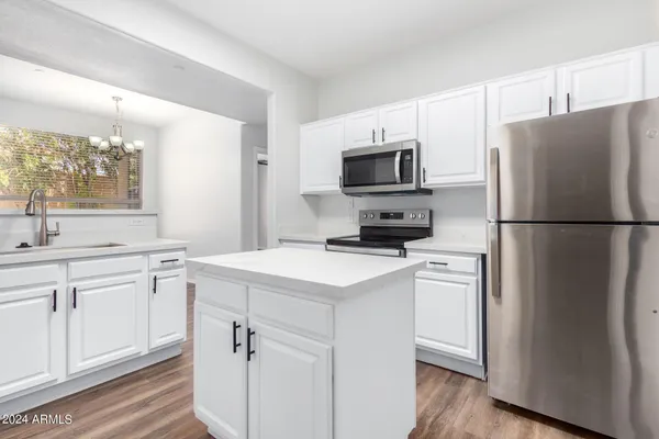 a kitchen with a refrigerator stove and sink