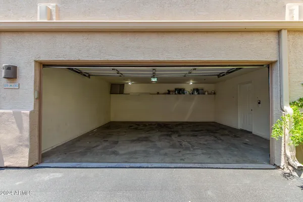 a view of a room with wooden floor and door