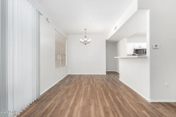 a view of a kitchen with wooden floor and a sink