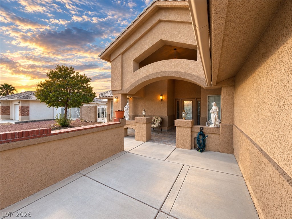 5470 Grain Mill Road Pahrump, NV 89061 - Photo 2 of 80 An inviting courtyard entrance showcases timeless stucco architectural details under an open sky.