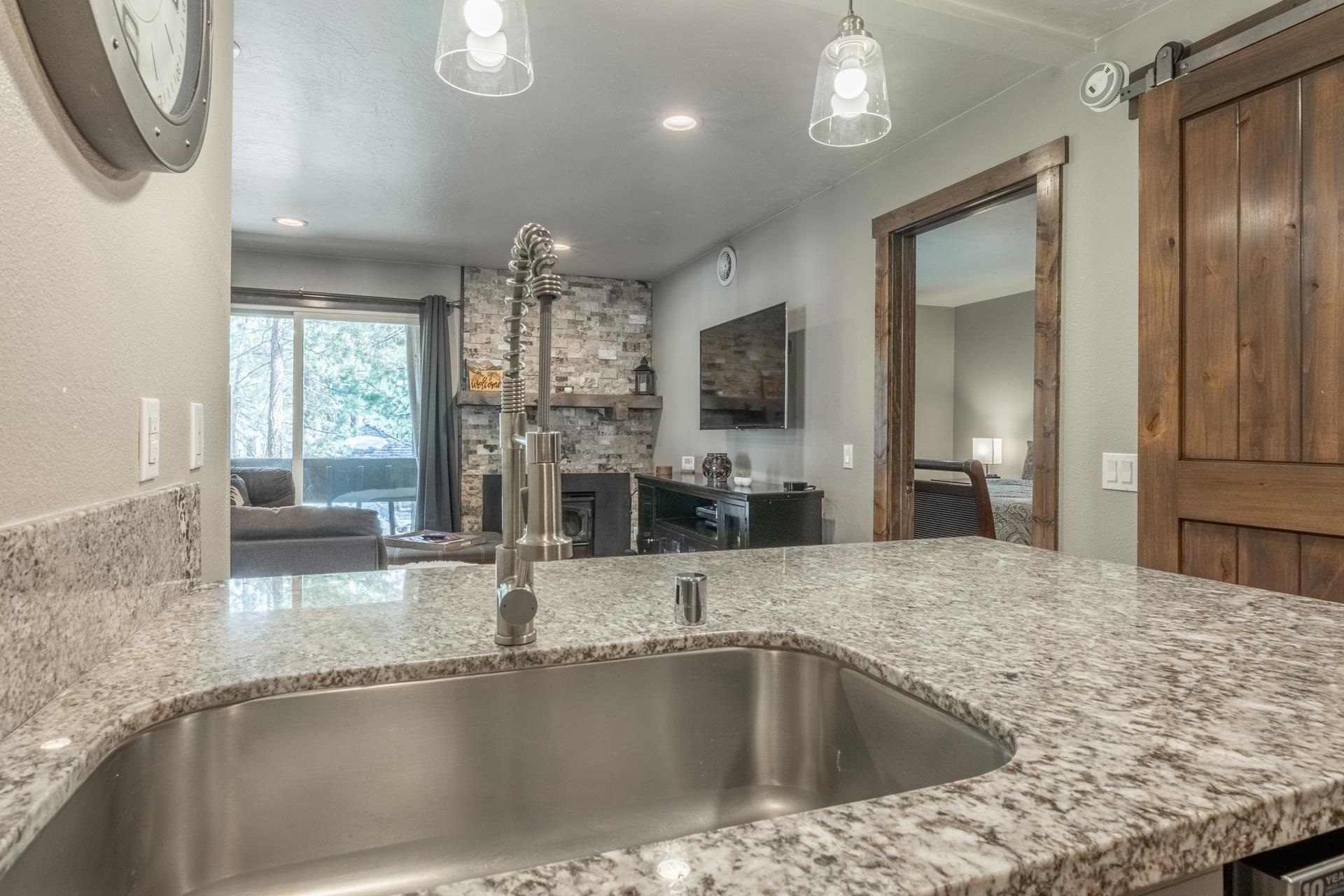 2499 Sierra Nevada Road, Unit S1 Mammoth Lakes, CA 93546 - Photo 13 of 38 Kitchen with light stone counters, recessed lighting, and a barn door
