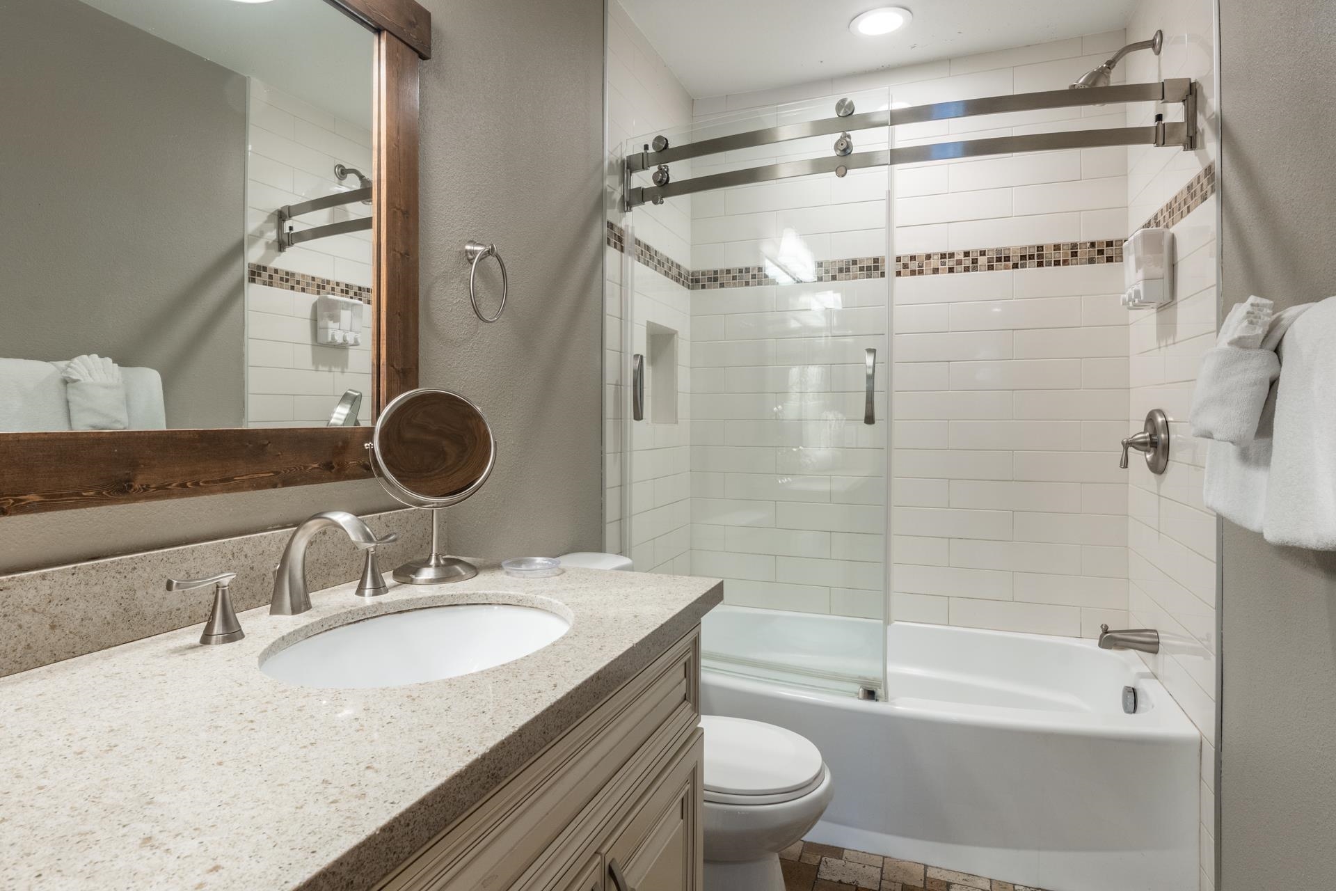 2499 Sierra Nevada Road, Unit S1 Mammoth Lakes, CA 93546 - Photo 22 of 38 Full bathroom featuring a textured wall, vanity, and shower / bath combination with glass door