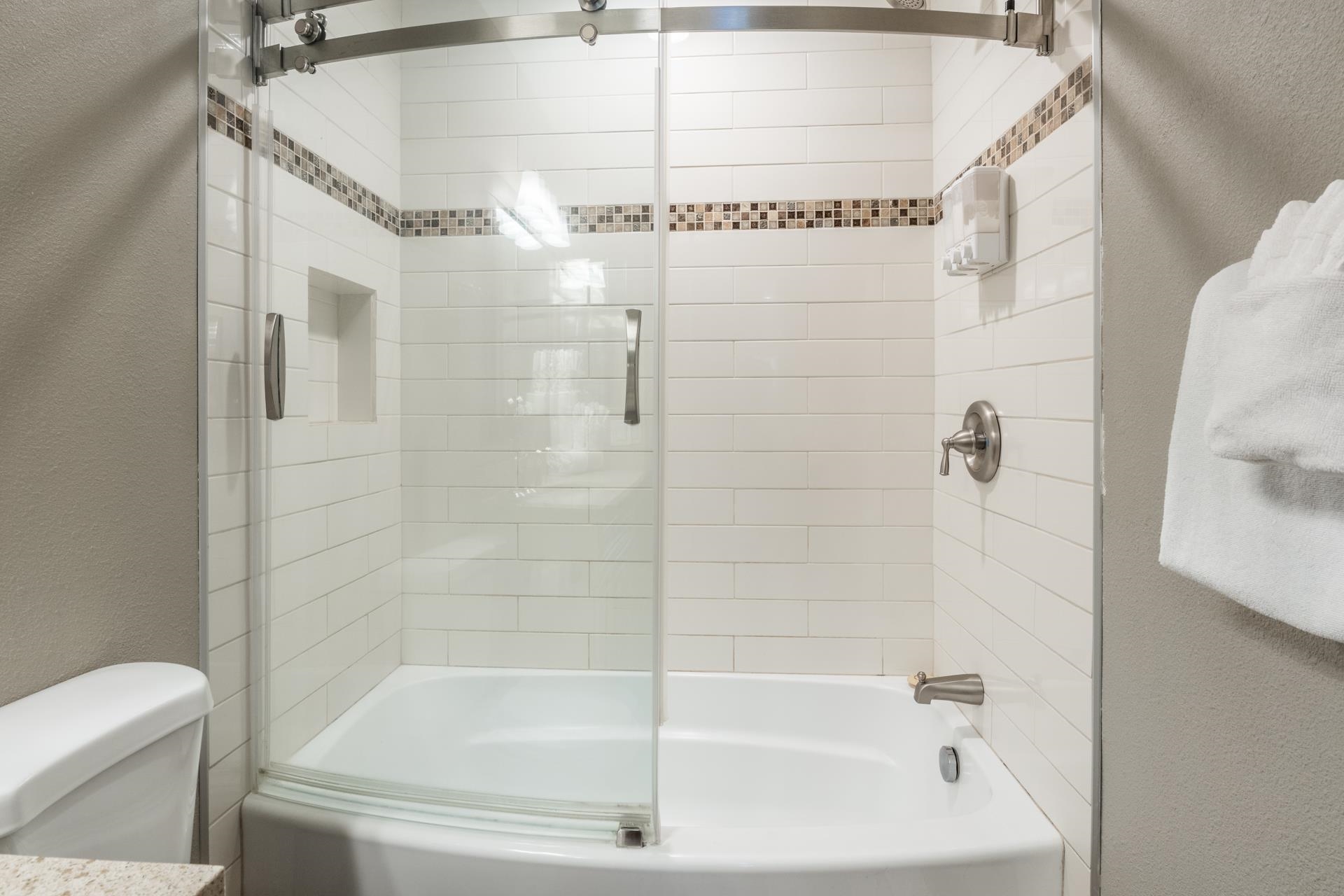 2499 Sierra Nevada Road, Unit S1 Mammoth Lakes, CA 93546 - Photo 23 of 38 Bathroom featuring a textured wall and shower / bath combination with glass door