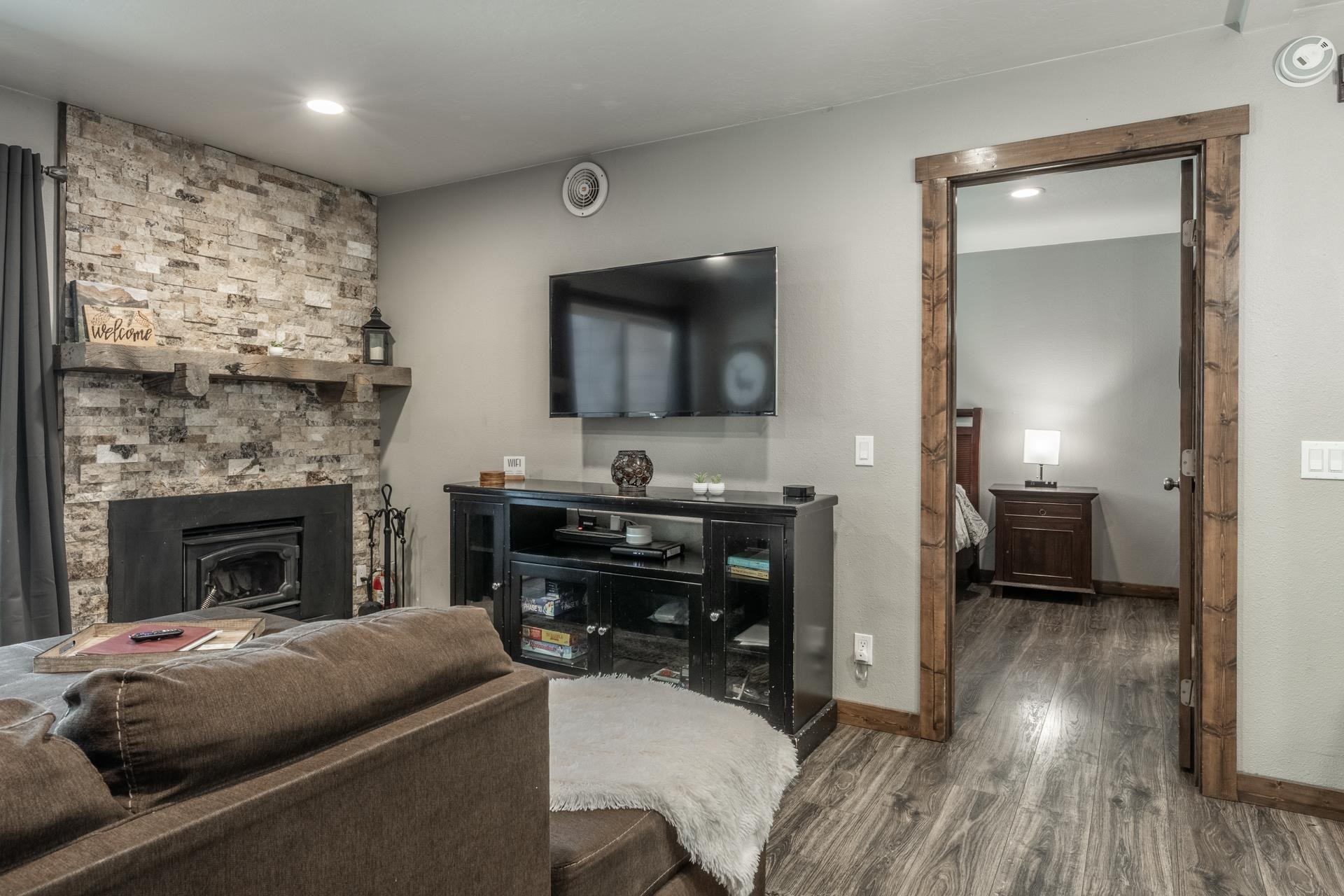 2499 Sierra Nevada Road, Unit S1 Mammoth Lakes, CA 93546 - Photo 6 of 38 Living area featuring wood finished floors, a stone fireplace, and recessed lighting