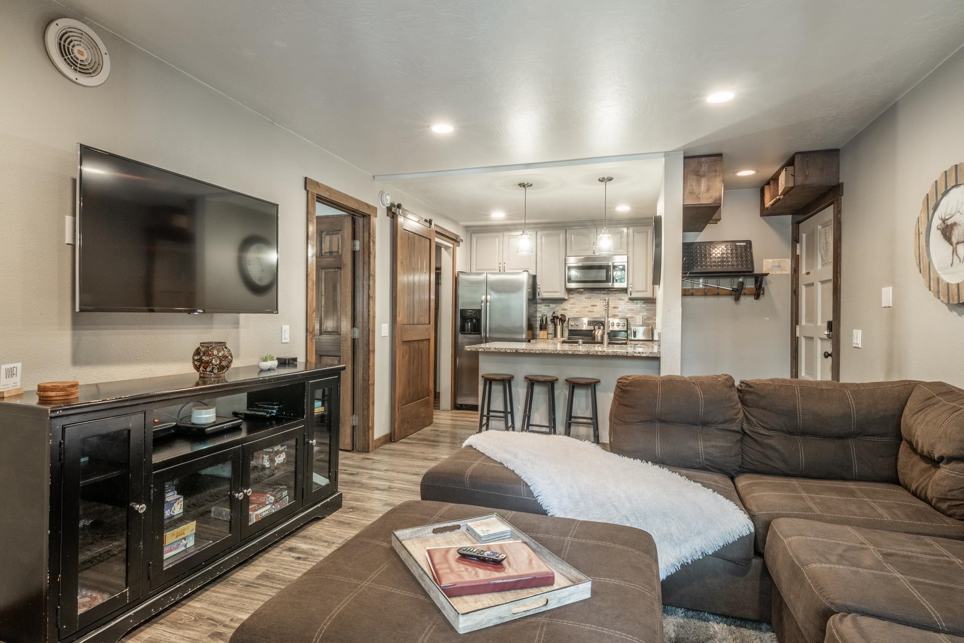 2499 Sierra Nevada Road, Unit S1 Mammoth Lakes, CA 93546 - Photo 7 of 38 Living room featuring a barn door, light wood-style flooring, and recessed lighting