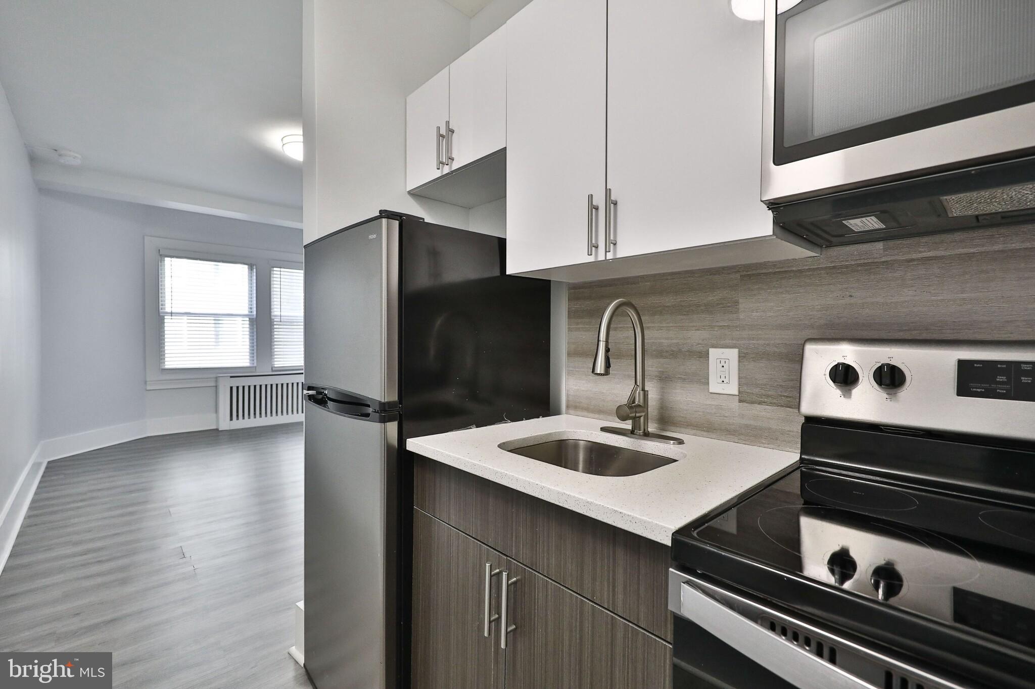 4247 Locust Street, Unit 0B908 Philadelphia, PA 19104 - Photo 8 of 38 a kitchen with a sink cabinets and appliances