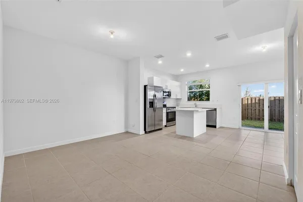 a kitchen with stainless steel appliances a refrigerator and a stove top oven