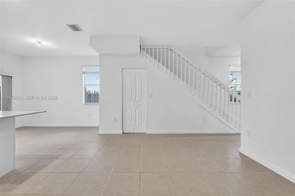 a view of room with white walls and white walls