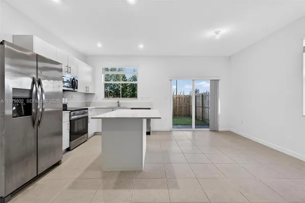 a kitchen with a sink stainless steel appliances and cabinets