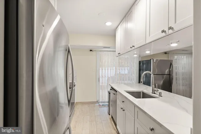 a kitchen with stainless steel appliances a refrigerator and a sink