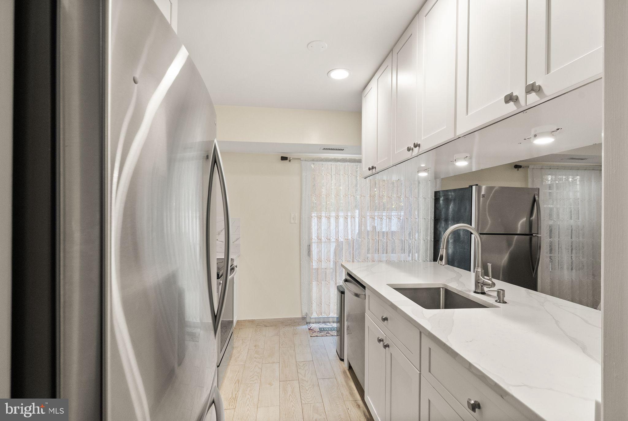 a kitchen with stainless steel appliances a refrigerator and a sink