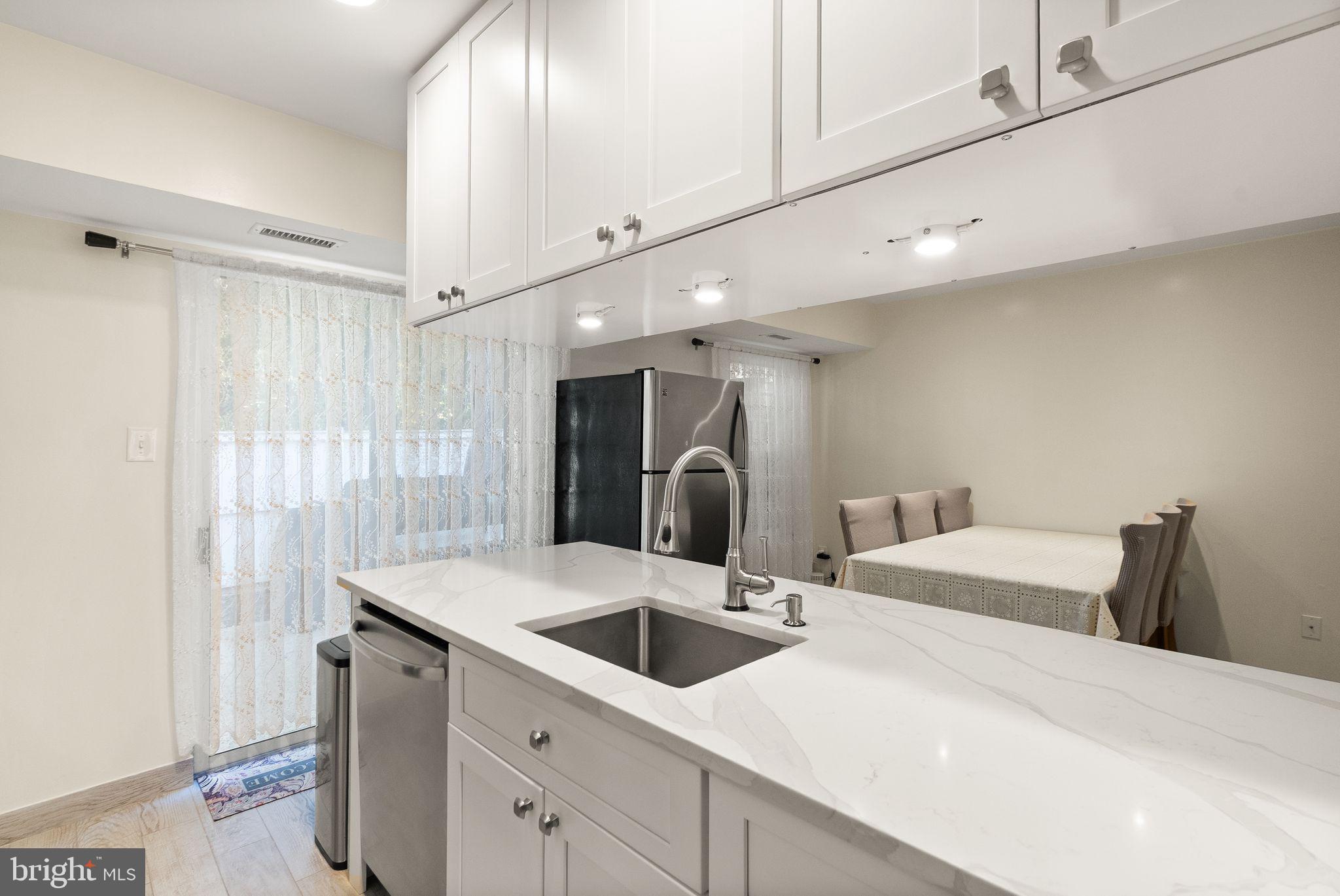 346 Lancaster Square Sterling, VA 20164 - Photo 2 of 24 a kitchen with a sink a counter and appliances