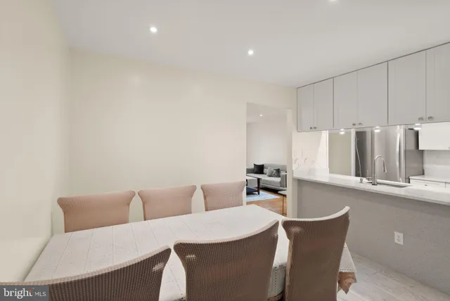 a room with a table chairs and wooden floor