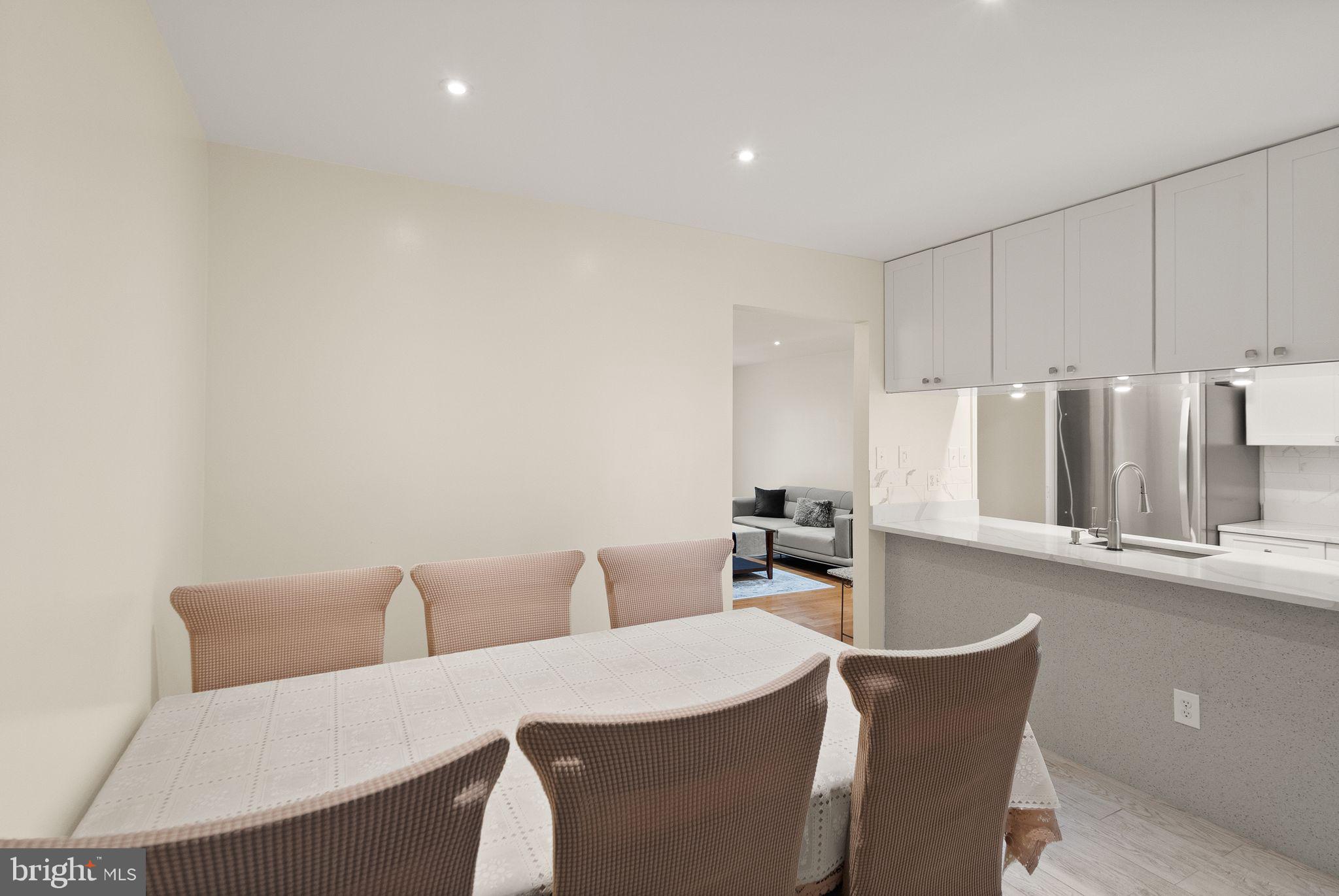 346 Lancaster Square Sterling, VA 20164 - Photo 10 of 24 a room with a table chairs and wooden floor