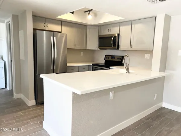 a kitchen with a refrigerator sink and microwave