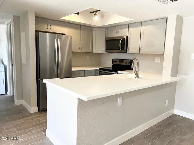 a kitchen with a refrigerator sink and microwave