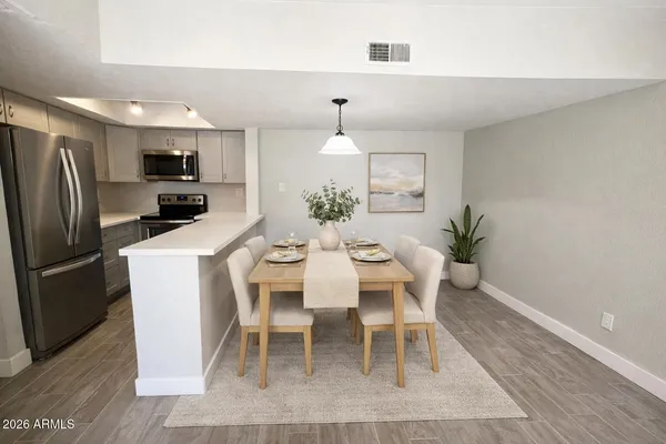 a dining room with furniture a rug and wooden floor