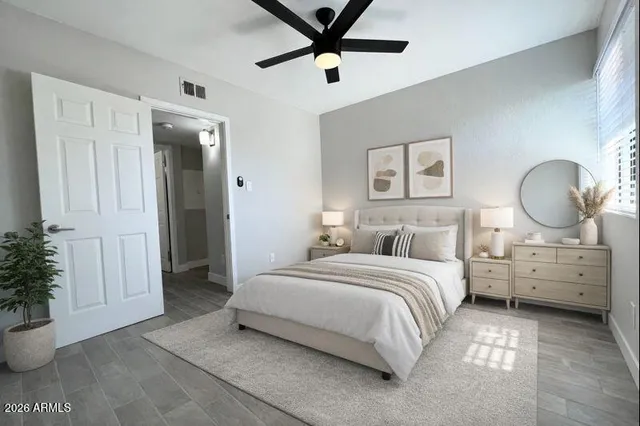 a bedroom with a bed and a chandelier