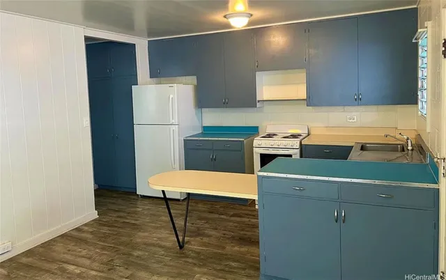 a room with a cabinets and a refrigerator