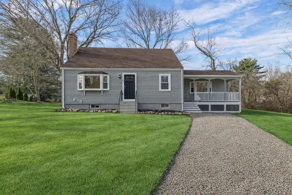 a front view of house with yard and green space