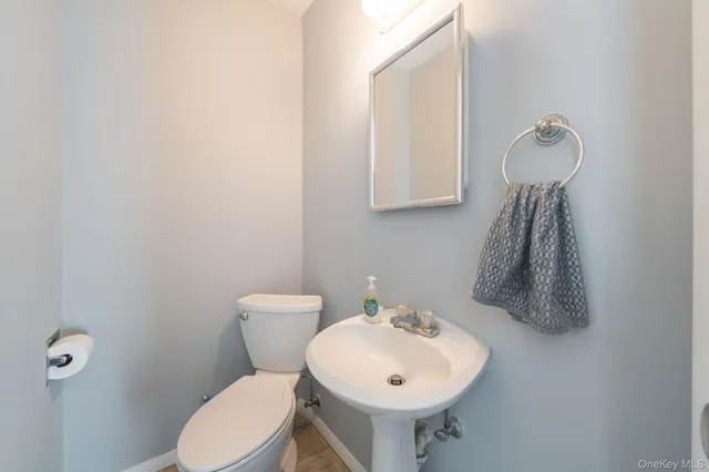 a bathroom with a sink a toilet and mirror