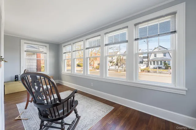 a view of a dining room with furniture windows and wooden floor