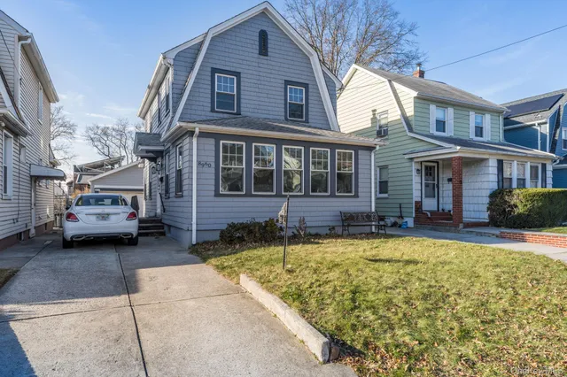 a view of a house with swimming pool and sitting area