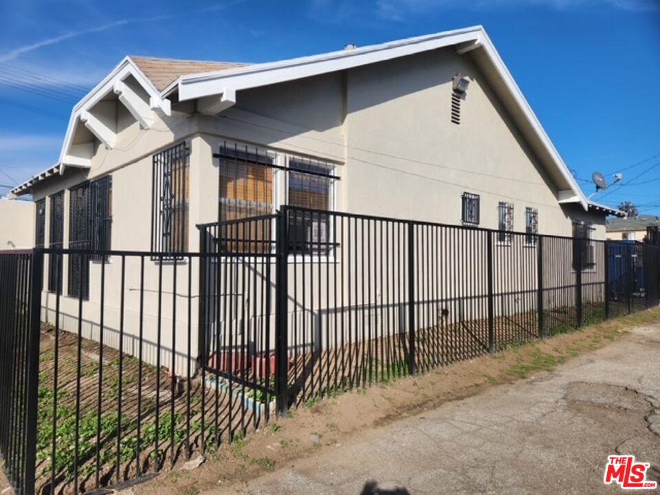 5806 3rd Avenue Los Angeles, CA 90043 - Photo 1 of 5 a view of a small house and iron fence