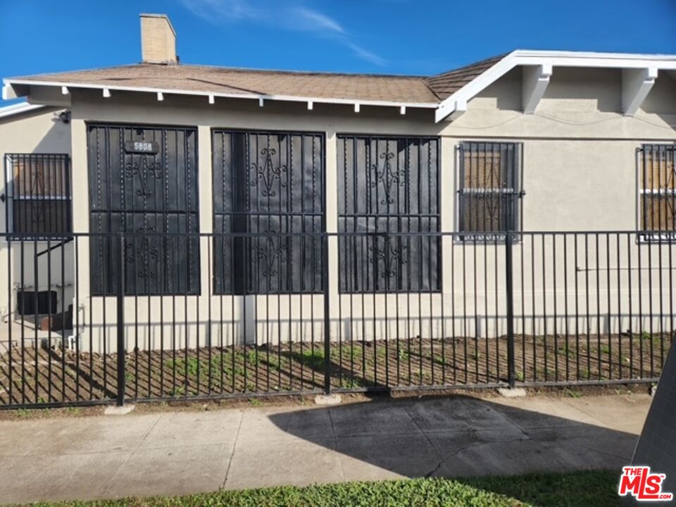 5806 3rd Avenue Los Angeles, CA 90043 - Photo 2 of 5 a front view of a house with a iron gate