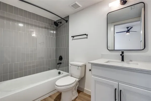 a bathroom with a sink a toilet and a bathtub