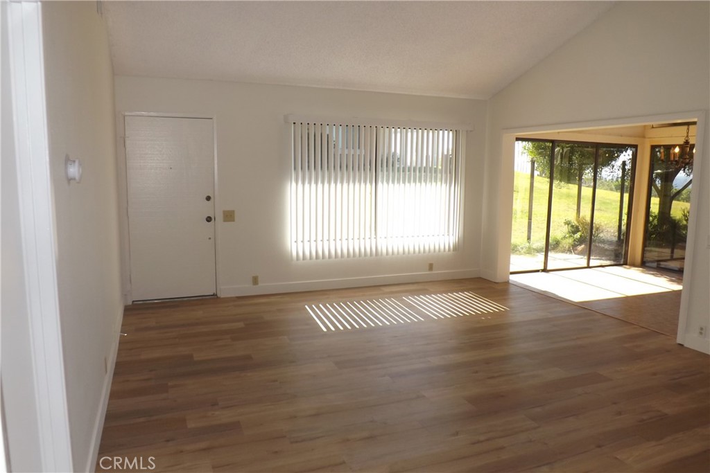 130 Avenida Adobe San Clemente, CA 92672 - Photo 10 of 26 an empty room with wooden floor and windows