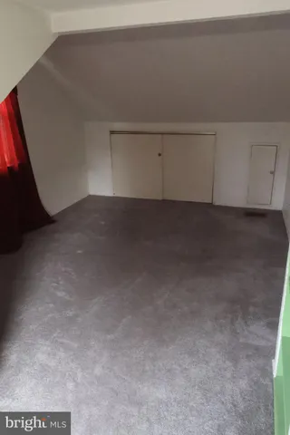 a bedroom with a bed and a window with outer view