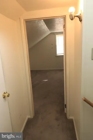 a view of a bathroom with a glass door and a window