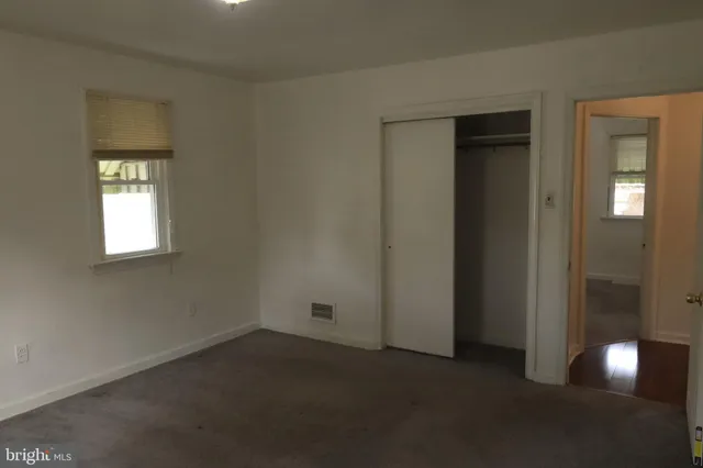 a view of room with flat screen tv and refrigerator