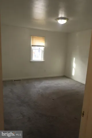 a view of a kitchen with refrigerator and cabinet